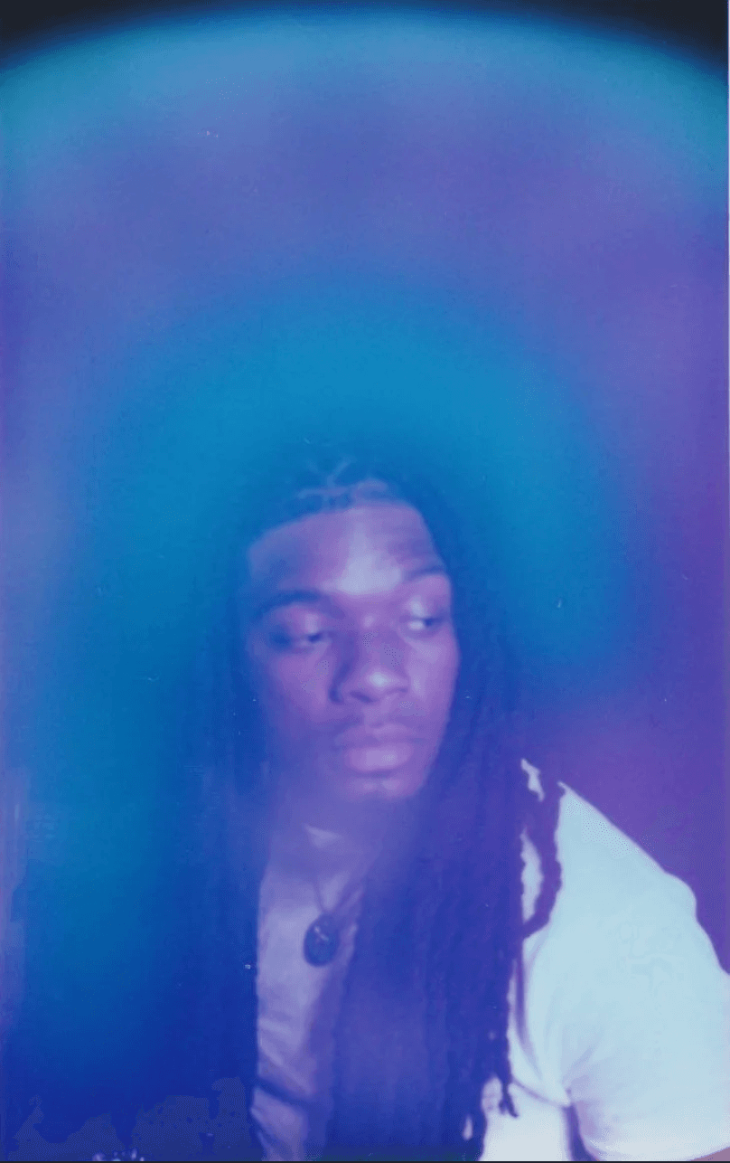 Aura portrait of a person with long locs in a white shirt against a deep indigo-blue aura