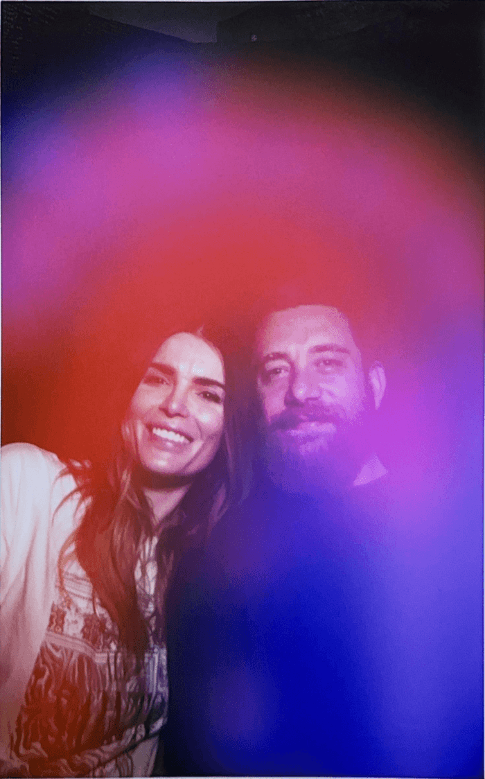 Aura portrait of two people smiling together, framed by a magenta-and-blue aura